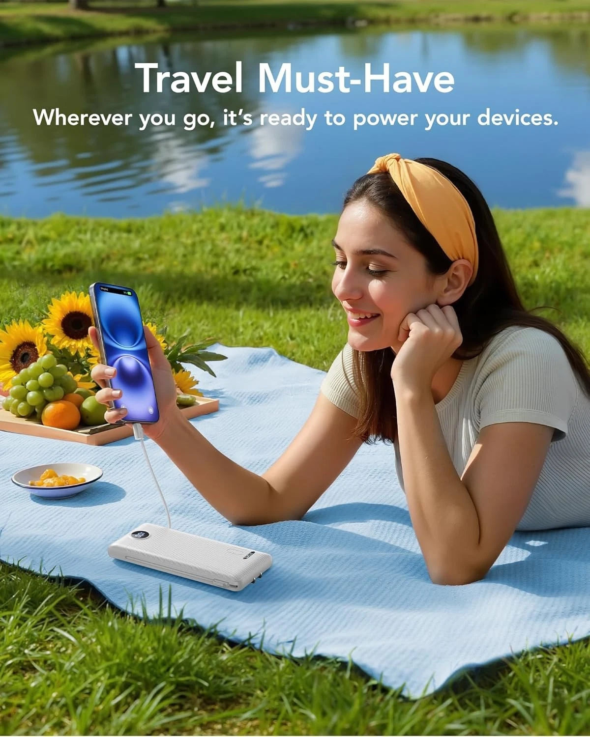 Travel lifestyle image showing the portable charger powering a phone outdoors